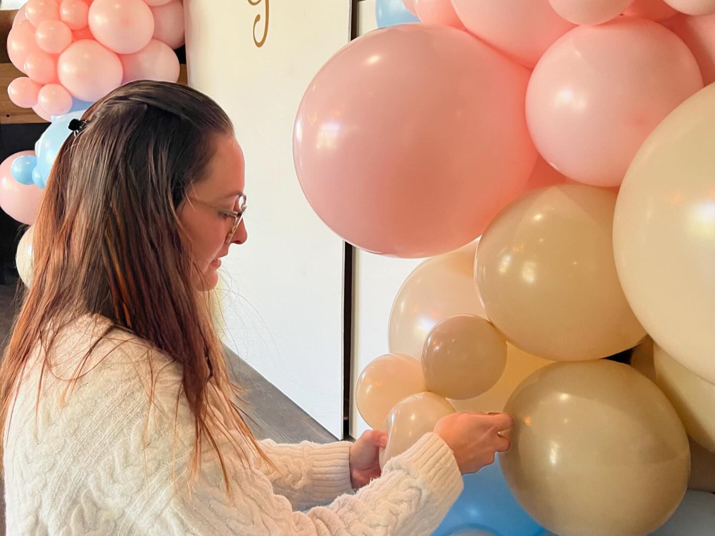 Clémy, fondatrice de Water Bear Events en train d'ajuster une arche de ballons pour un événement